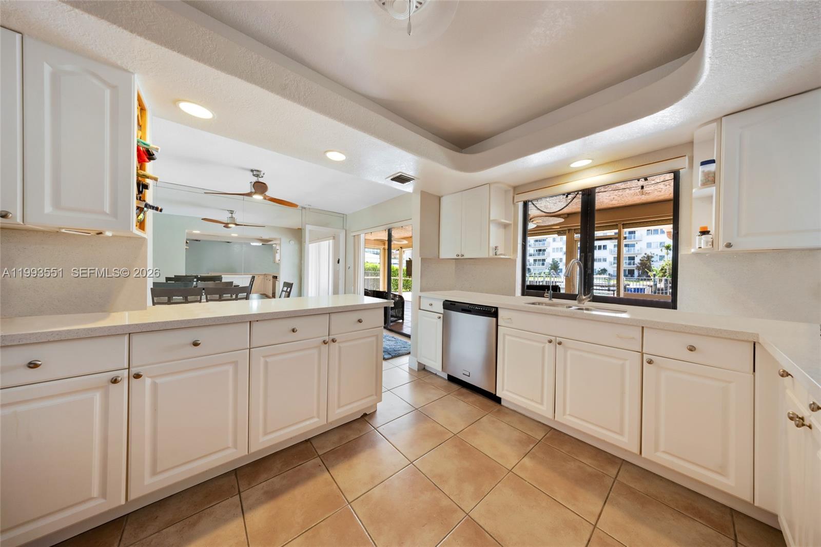 2752 Northeast 3rd Street Pompano Beach, FL 33062 - Photo 11 of 45 a large white kitchen with a large window