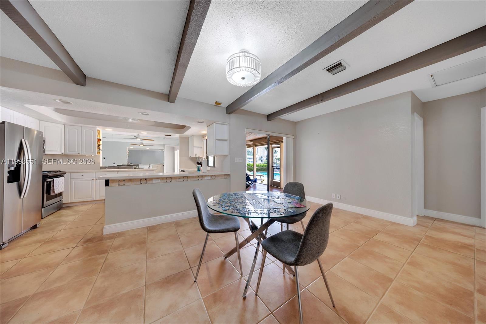 2752 Northeast 3rd Street Pompano Beach, FL 33062 - Photo 12 of 45 a dining room with furniture and window