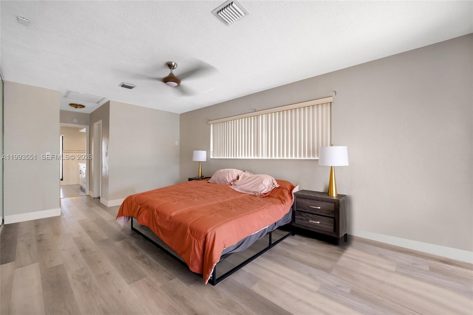 2752 Northeast 3rd Street Pompano Beach, FL 33062 - Photo 15 of 45 a bedroom with a bed and wooden floor
