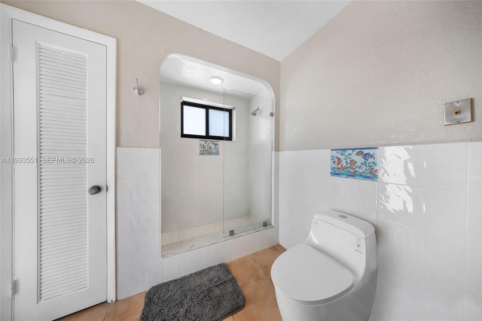 2752 Northeast 3rd Street Pompano Beach, FL 33062 - Photo 21 of 45 a white toilet sitting next to a bath tub