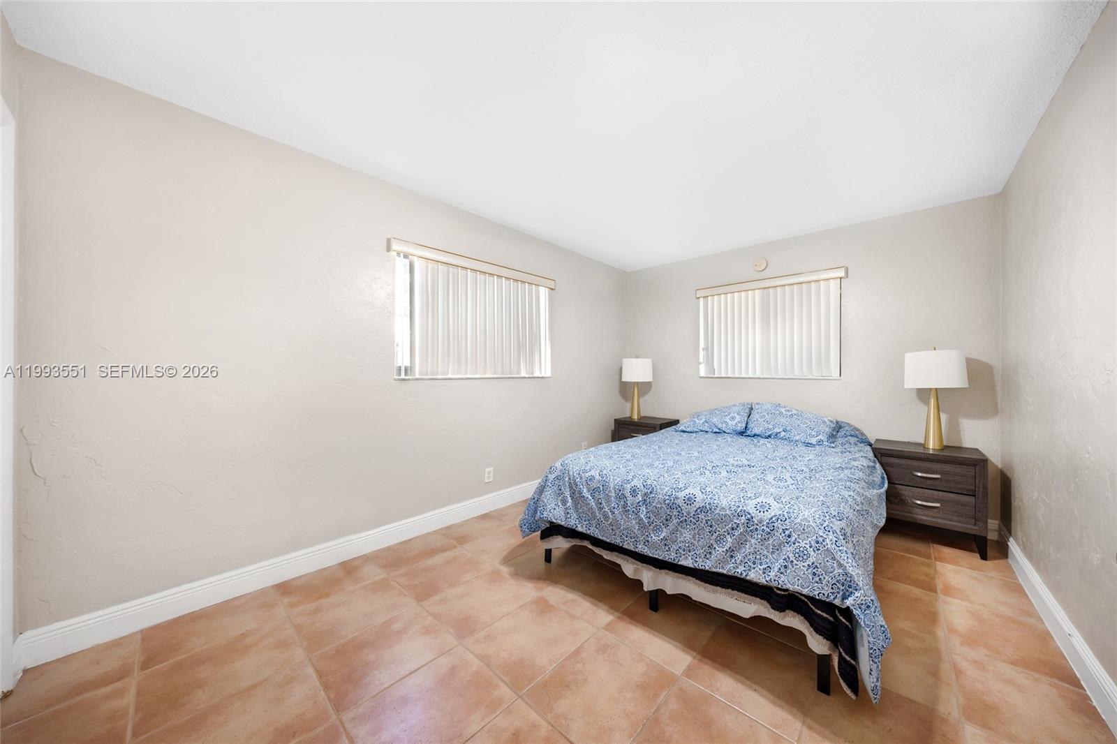 2752 Northeast 3rd Street Pompano Beach, FL 33062 - Photo 22 of 45 a bedroom with a bed and window