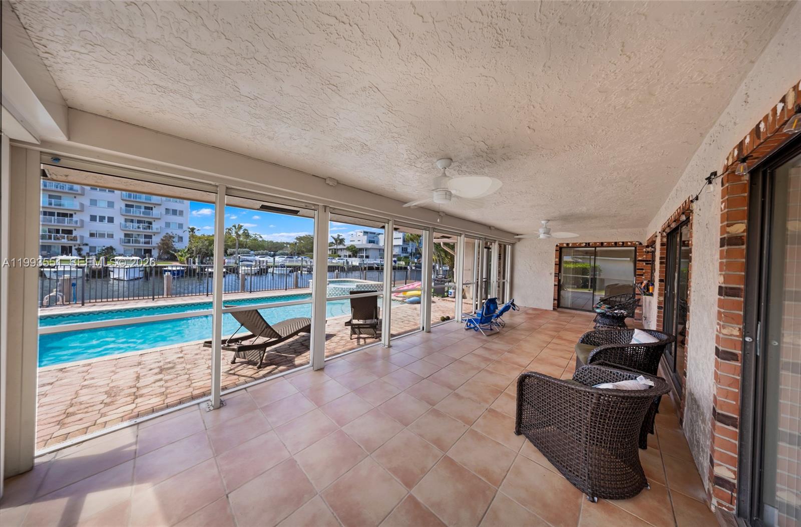2752 Northeast 3rd Street Pompano Beach, FL 33062 - Photo 25 of 45 a living room with furniture and a floor to ceiling window