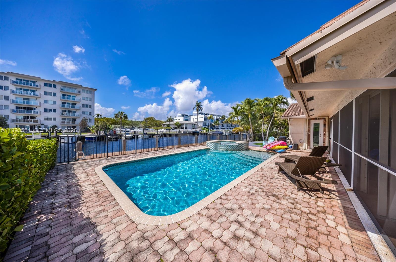 2752 Northeast 3rd Street Pompano Beach, FL 33062 - Photo 28 of 45 a view of a swimming pool with sitting area