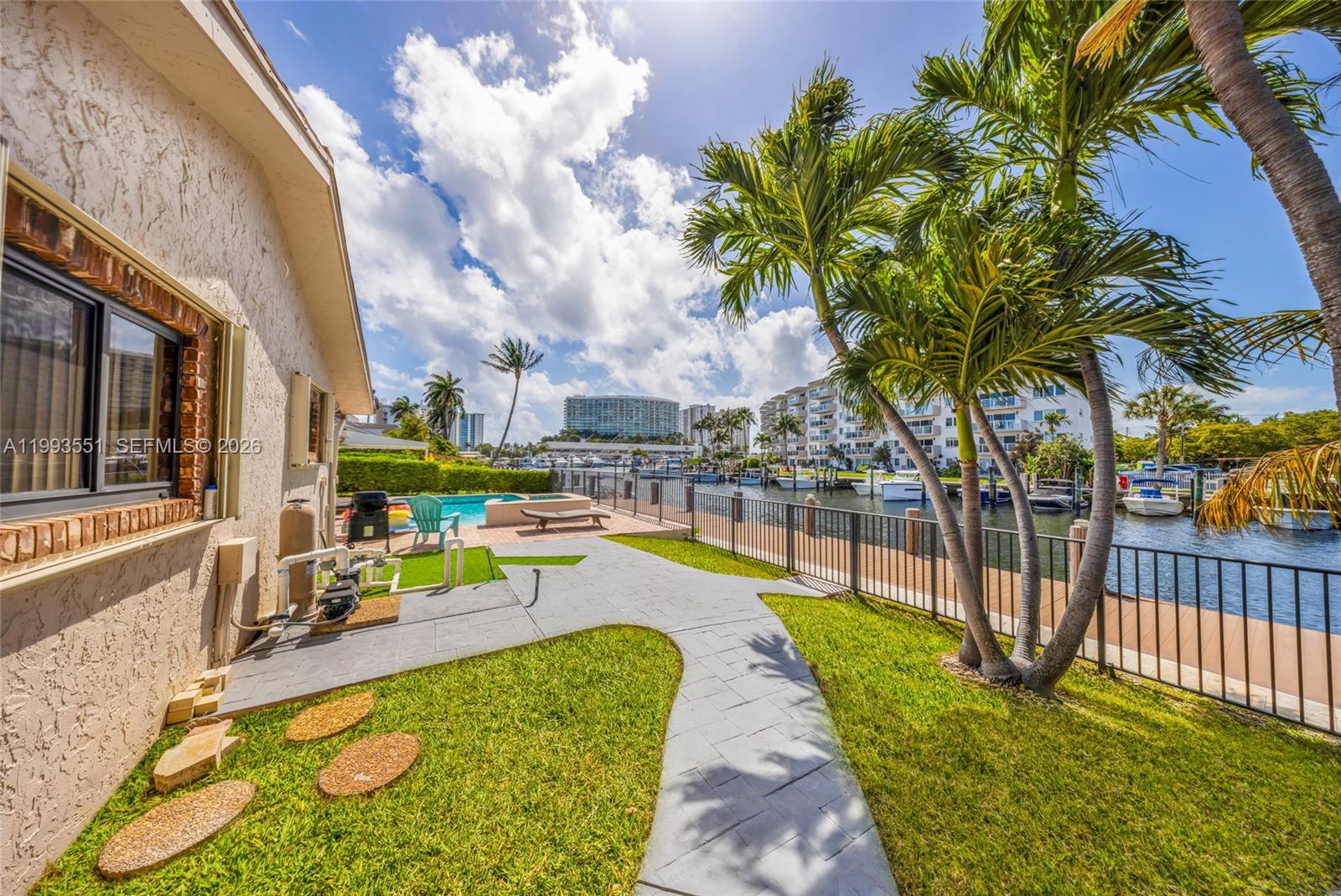 2752 Northeast 3rd Street Pompano Beach, FL 33062 - Photo 30 of 45 a view of a swimming pool with a lounge chair