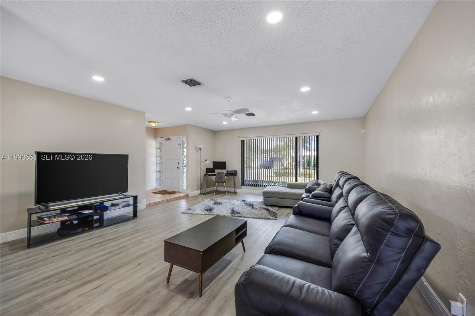 2752 Northeast 3rd Street Pompano Beach, FL 33062 - Photo 8 of 45 a living room with furniture and a flat screen tv