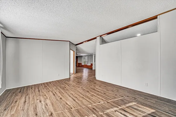 a view of kitchen with wooden floor and electronic appliances