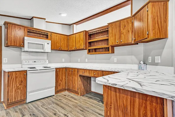 a kitchen with stainless steel appliances granite countertop a sink and wooden cabinets