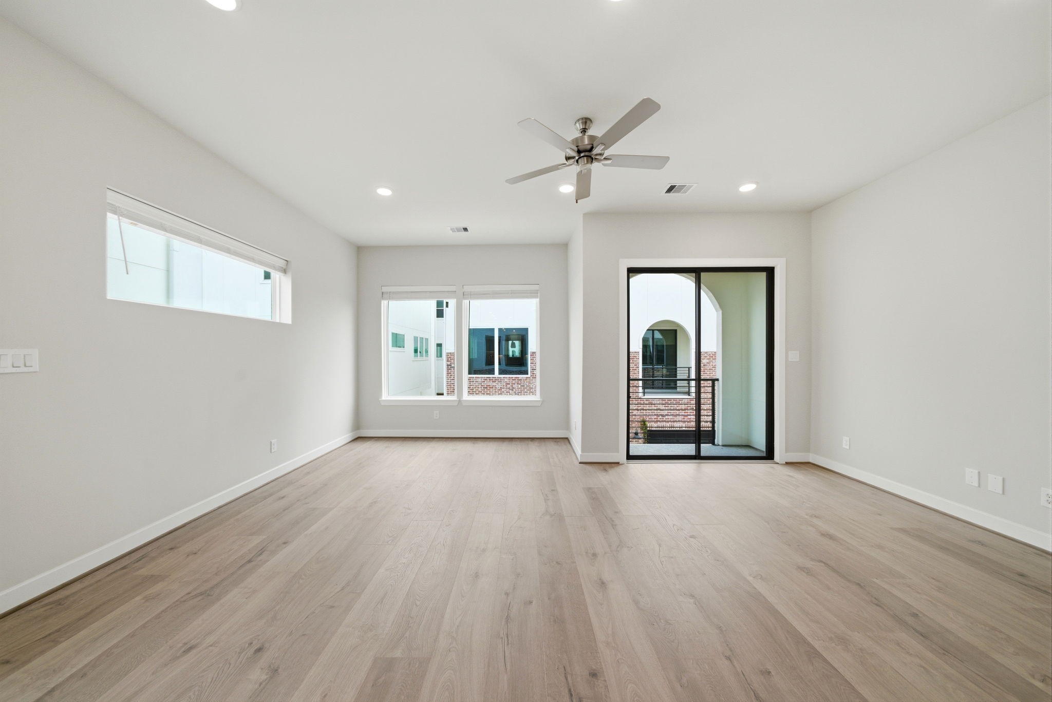 3073 Hicks Street Houston, TX 77007 - Photo 10 of 33 a view of an empty room with a window and wooden floor