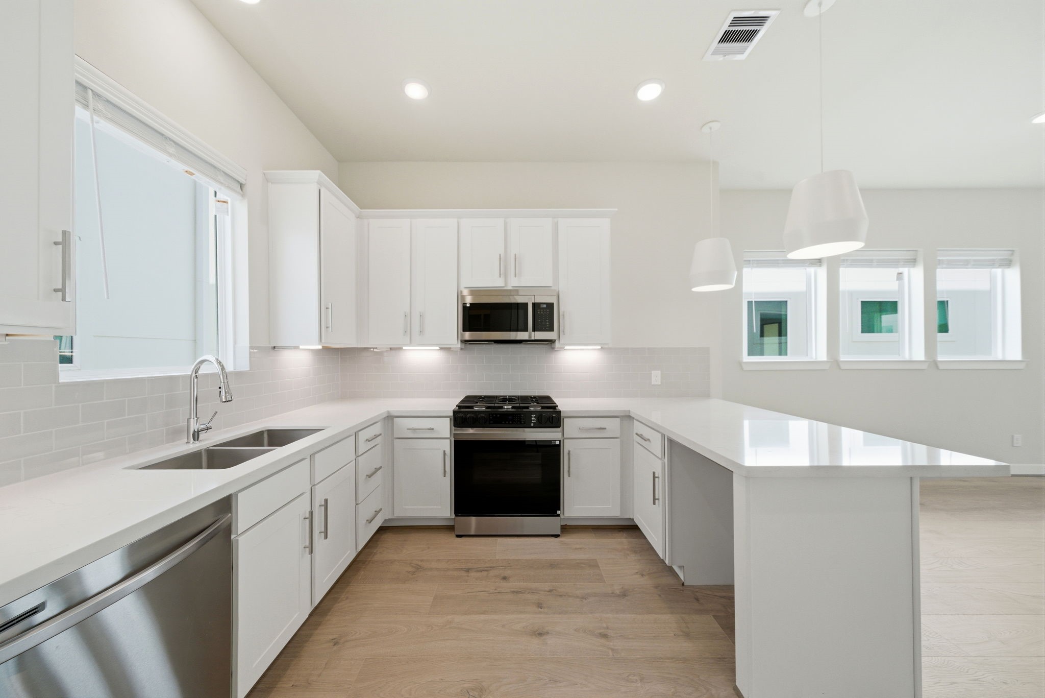 3073 Hicks Street Houston, TX 77007 - Photo 12 of 33 a kitchen with a sink stove and cabinets