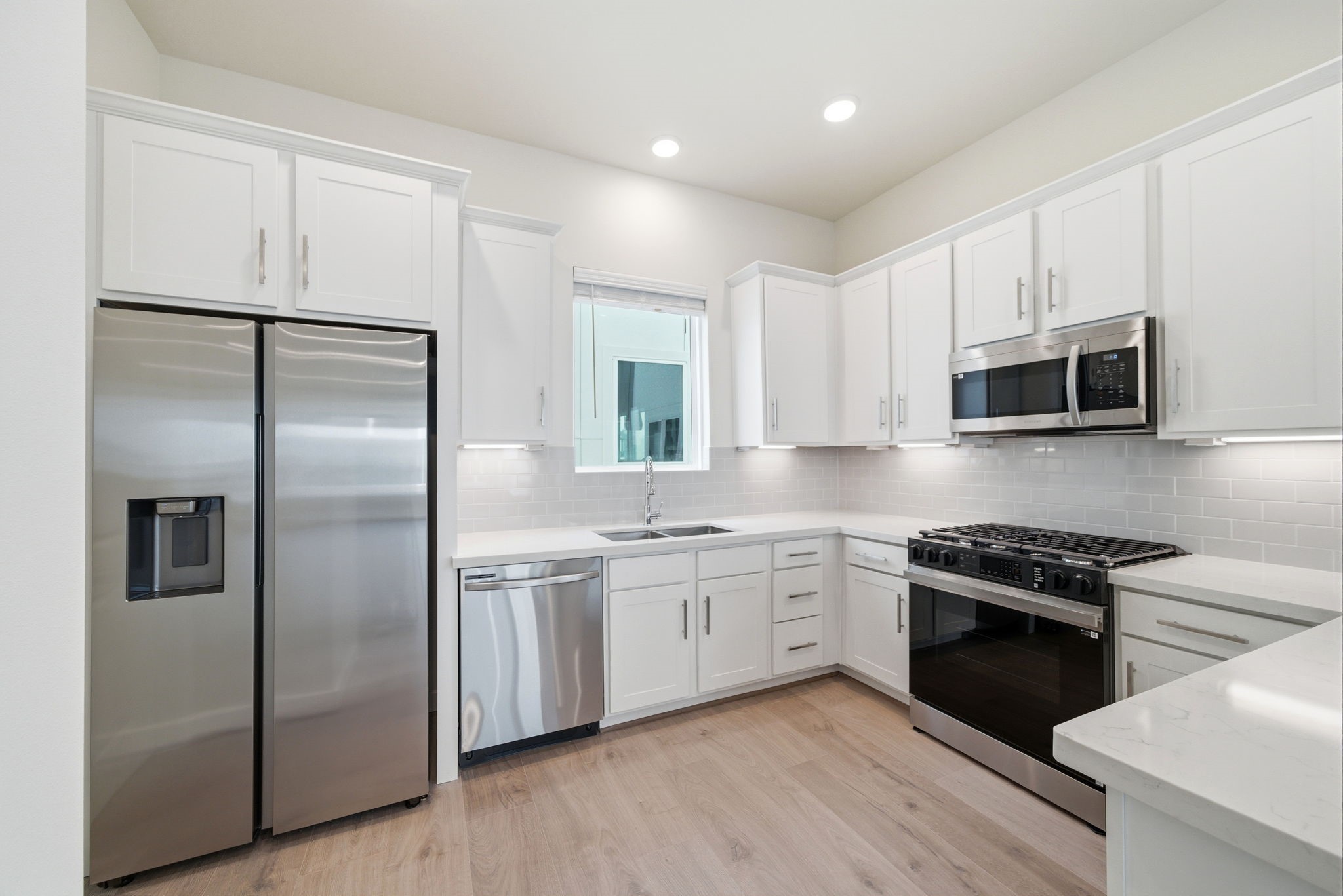 3073 Hicks Street Houston, TX 77007 - Photo 13 of 33 a kitchen with stainless steel appliances granite countertop a refrigerator a sink dishwasher a stove and a microwave oven on granite countertops