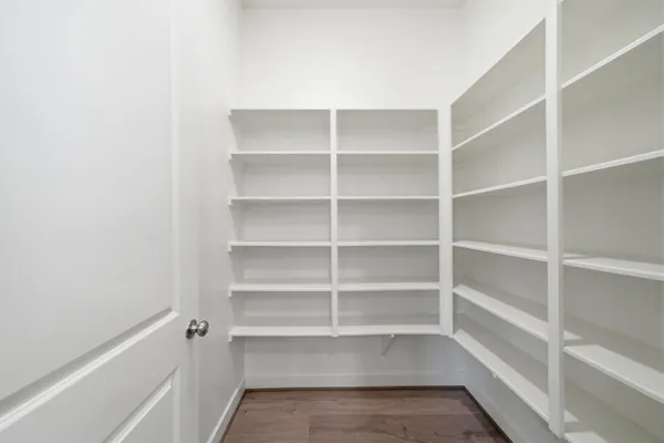 a view of a kitchen with white cabinets and refrigerator