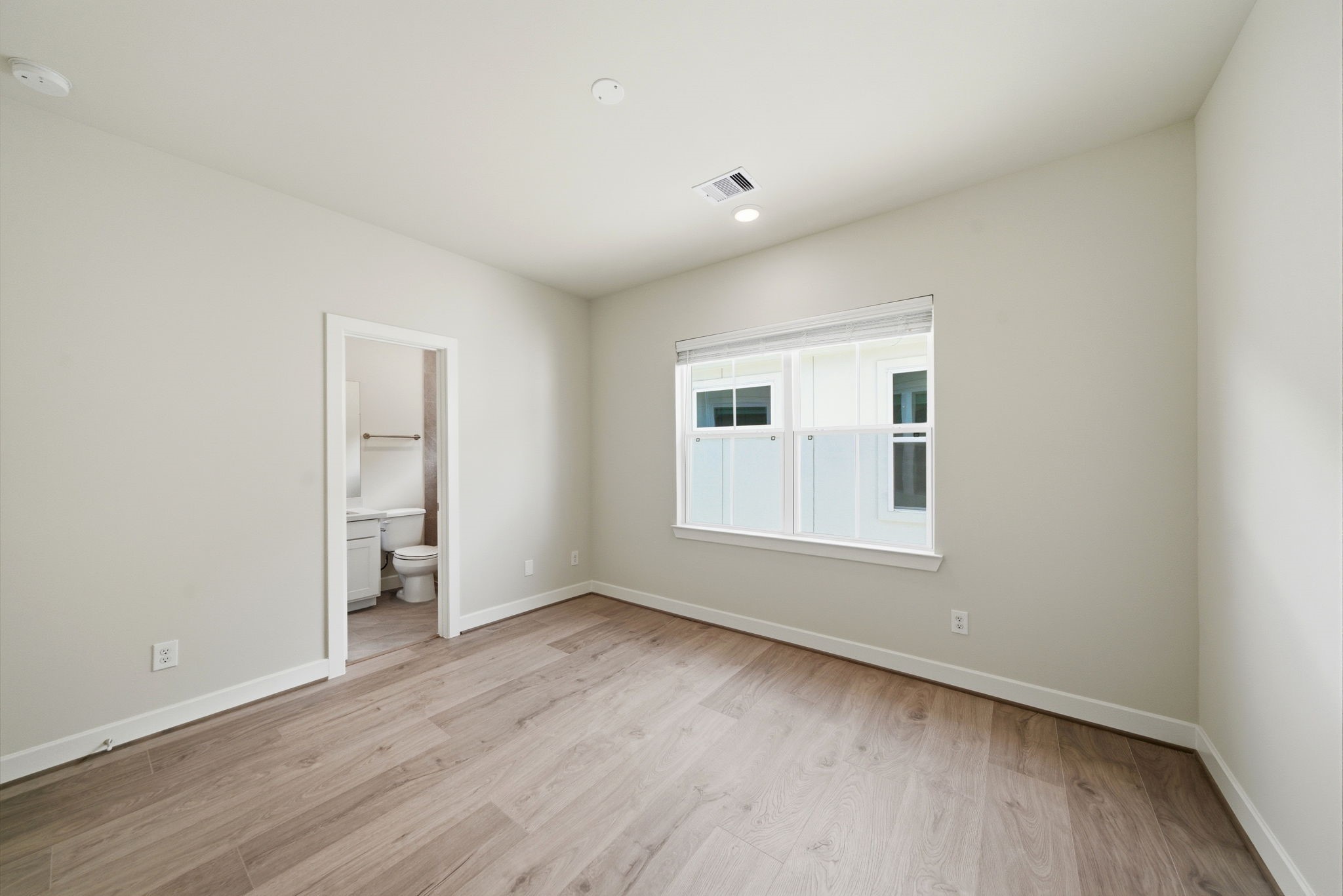 3073 Hicks Street Houston, TX 77007 - Photo 22 of 33 an empty room with wooden floor and windows