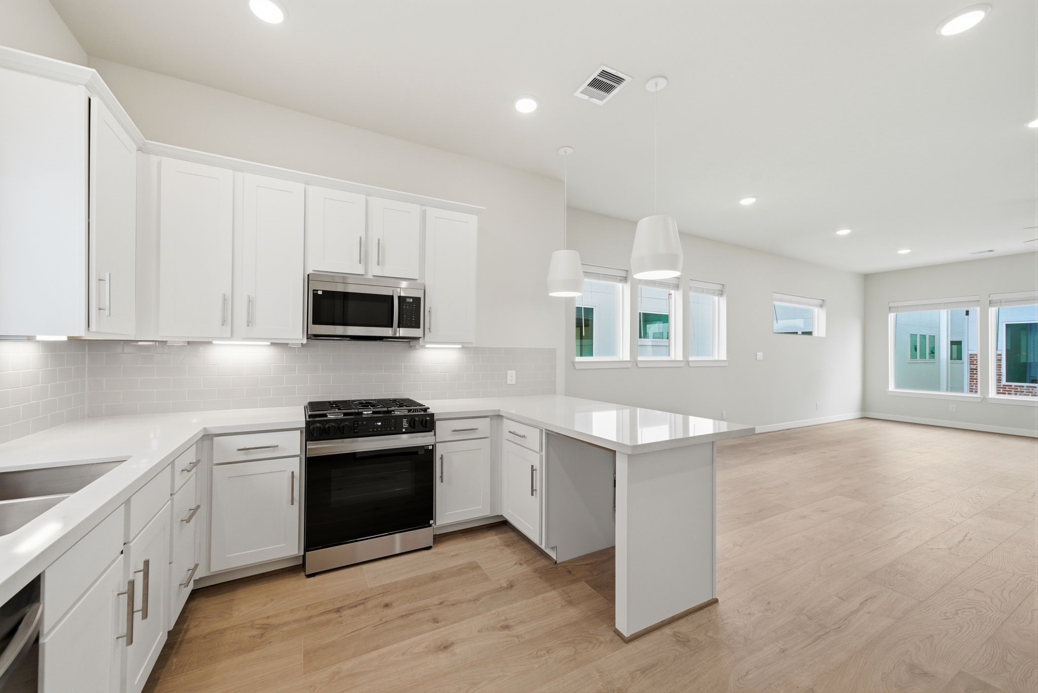 3073 Hicks Street Houston, TX 77007 - Photo 2 of 33 a kitchen with granite countertop white cabinets and stainless steel appliances