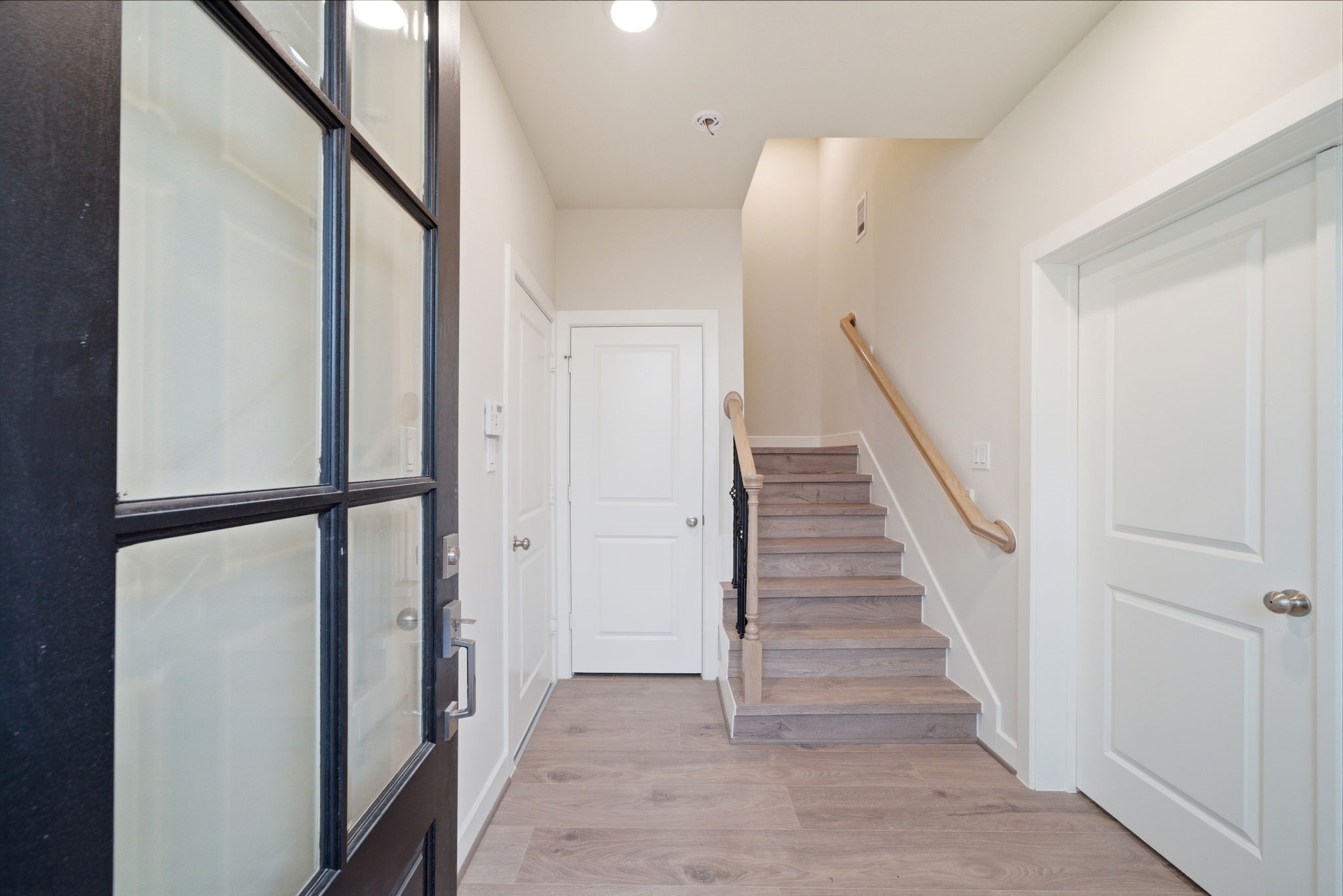 3073 Hicks Street Houston, TX 77007 - Photo 6 of 33 a view of a hallway with wooden floor and staircase