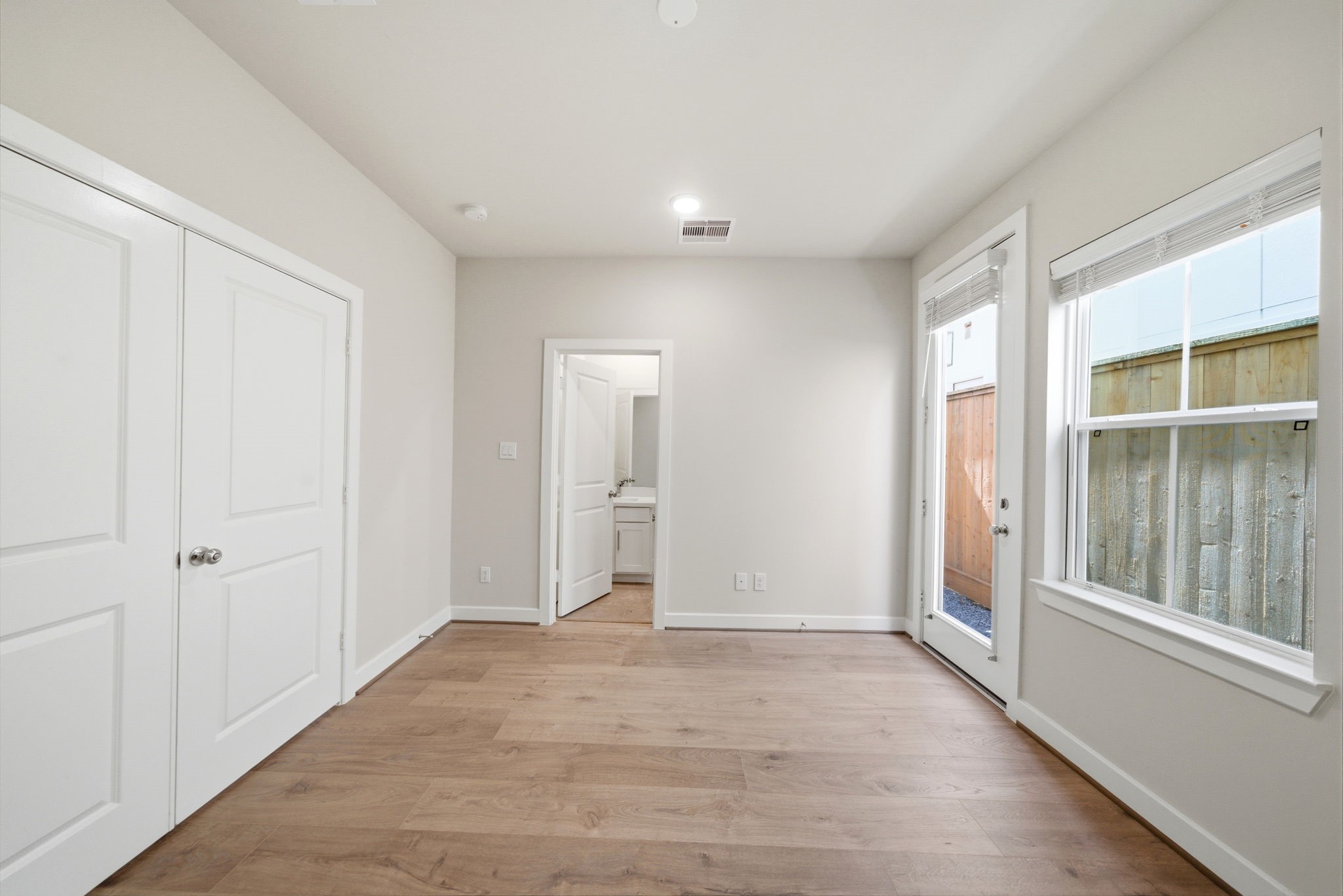 3073 Hicks Street Houston, TX 77007 - Photo 7 of 33 wooden floor in an empty room with a window