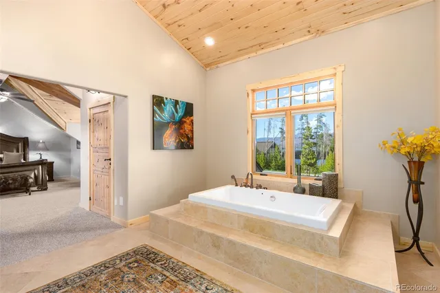 a bedroom with a bed a couch and a window