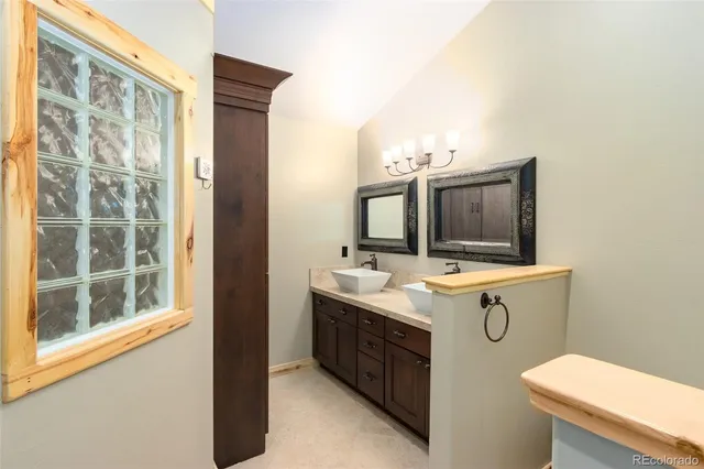 a view of bathroom with a sink and mirror