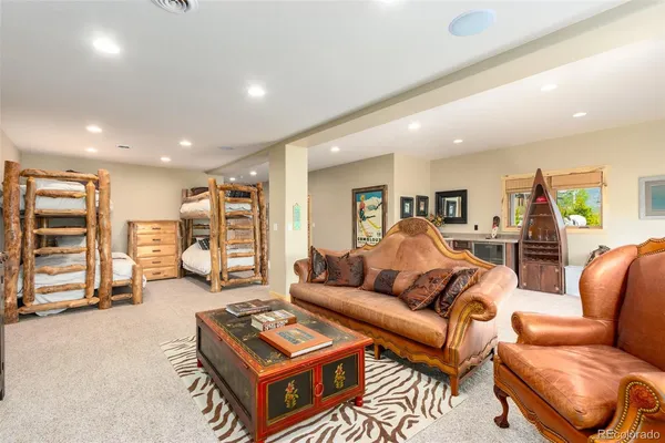 a living room with furniture a ceiling fan and a rug