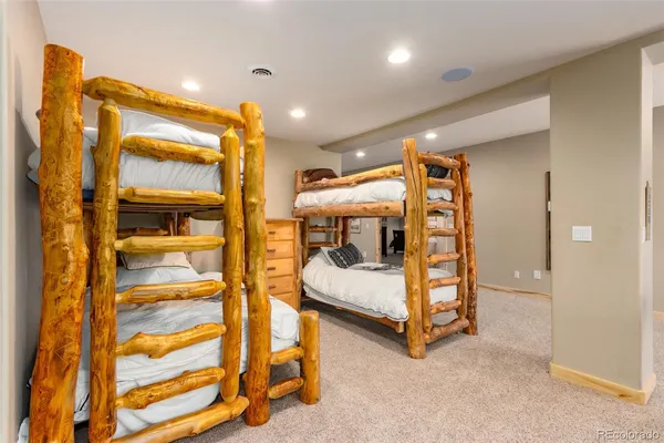 a bedroom with double bunk beds and a window