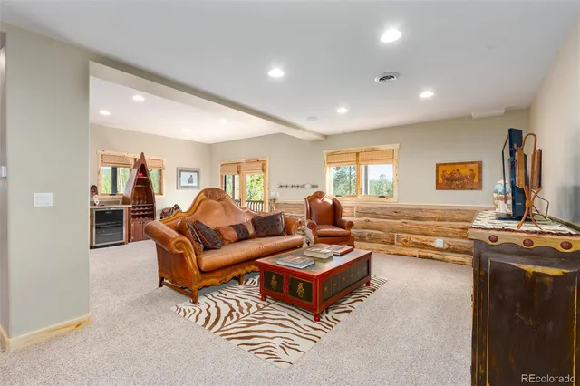 a living room with furniture a rug and a window