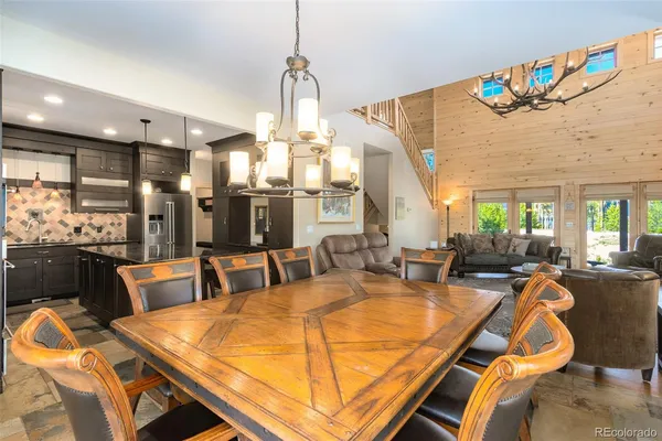 a dining room with furniture and a chandelier