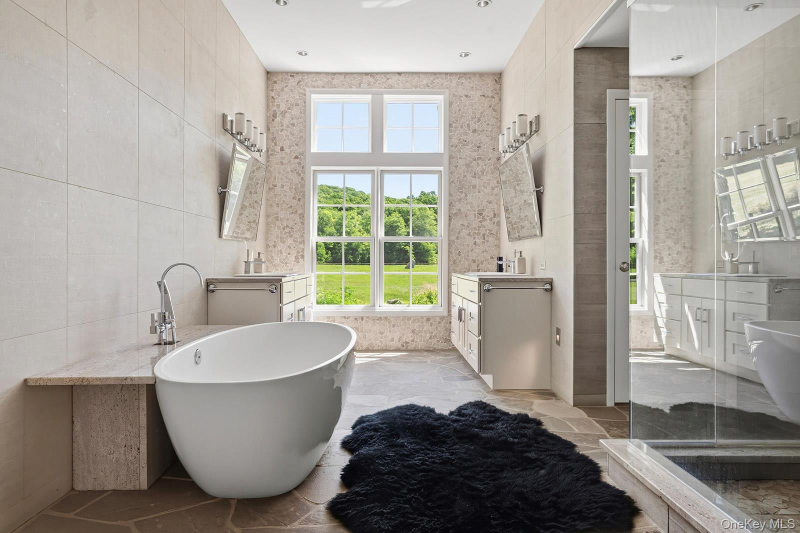 180 Dean Road Carmel, NY 10512 - Photo 16 of 50 Primary bathroom with twin vanities, soaking tub, large glass shower with dual rain shower heads, separate lavatory and radiant heated bluestone floors