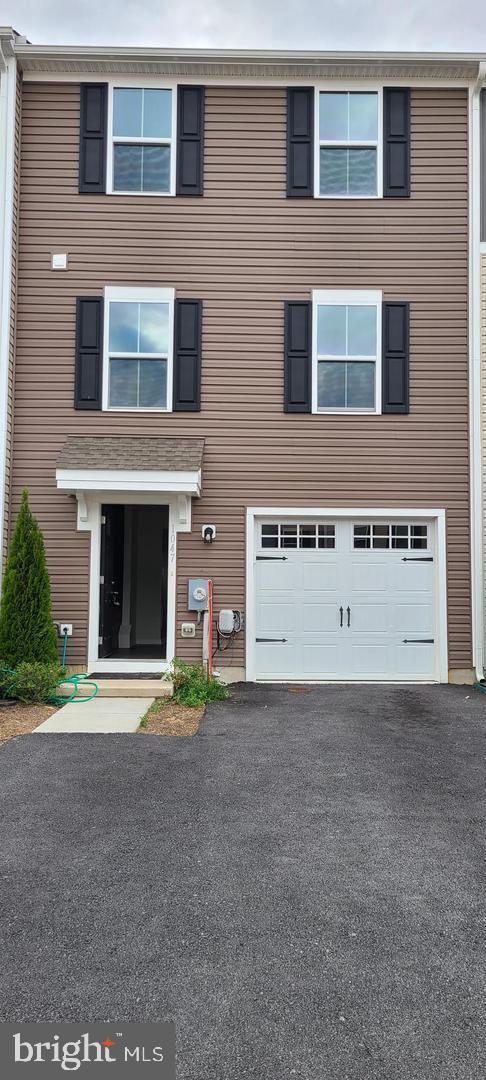 1047 Wickersham Way Middletown, DE 19709 - Photo 1 of 18 a front view of a building with a yard and garage