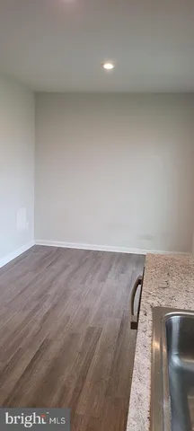 an empty room with wooden floor