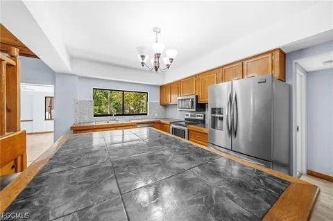 3745 27th Avenue Southwest Naples, FL 34117 - Photo 19 of 30 a view of a kitchen with a sink and a refrigerator