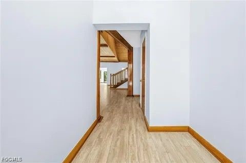 3745 27th Avenue Southwest Naples, FL 34117 - Photo 28 of 30 a view of a hallway with wooden floor and a bathroom
