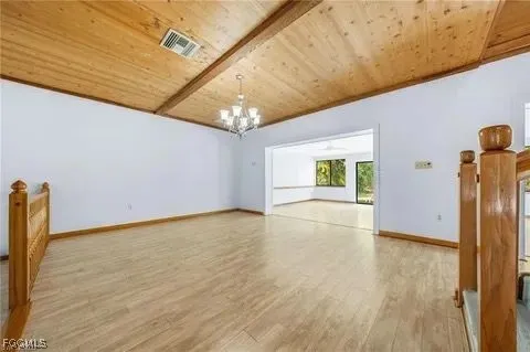 a view of a hallway with wooden floor and entryway