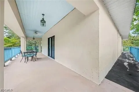 a view of a porch with furniture and a yard
