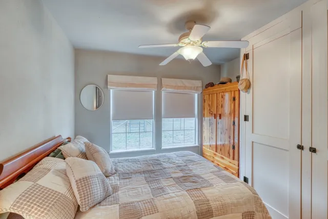 a bedroom with a bed and a chandelier