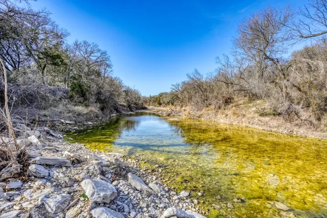 a view of a lake with a yard