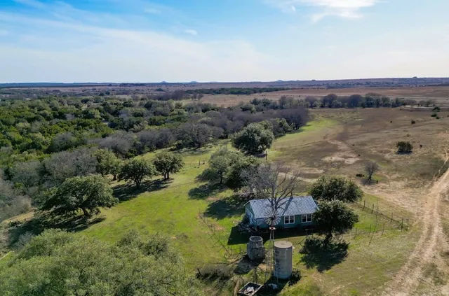 an aerial view of a houses with outdoor space