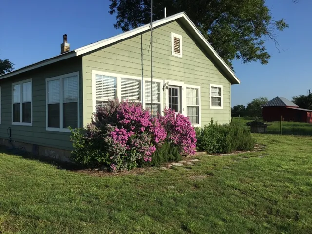 a view of a house with garden and yard