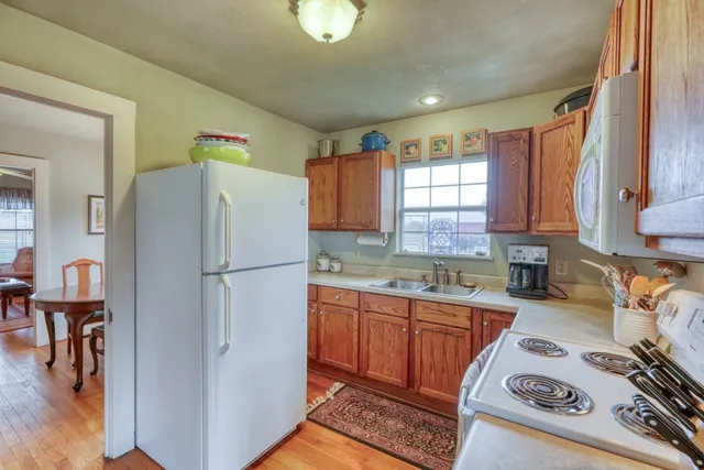 a white refrigerator freezer sitting inside of a kitchen