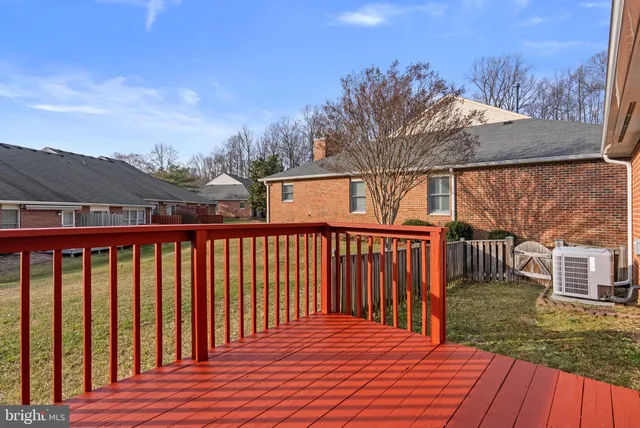 a balcony with wooden floor and fence