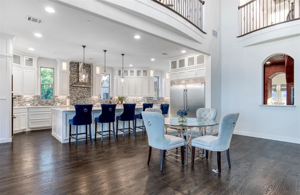 901 Inverness Court Lucas, TX 75002 - Photo 12 of 40 Dining space featuring dark wood-type flooring, recessed lighting, and a high ceiling