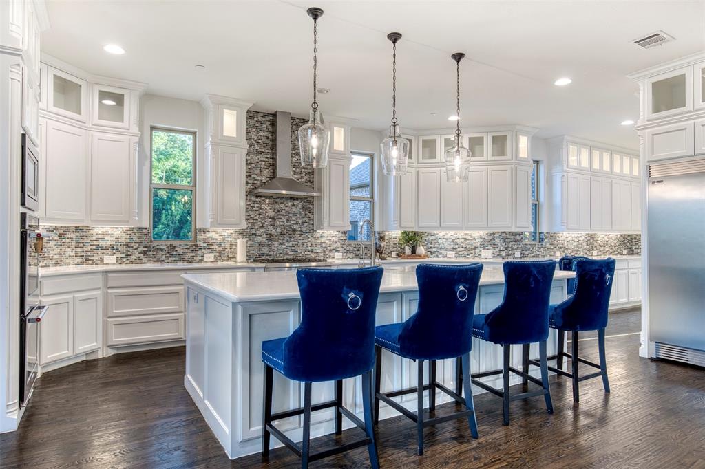 901 Inverness Court Lucas, TX 75002 - Photo 13 of 40 Kitchen with glass fronted cabinets, white cabinets, and decorative backsplash