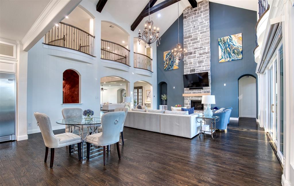 901 Inverness Court Lucas, TX 75002 - Photo 15 of 40 Dining room featuring arched walkways, a fireplace, dark wood finished floors, and a chandelier