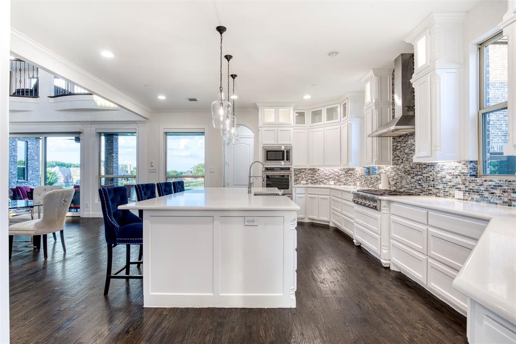901 Inverness Court Lucas, TX 75002 - Photo 17 of 40 Kitchen with white cabinets, decorative backsplash, dark wood finished floors, glass fronted cabinets, and crown molding
