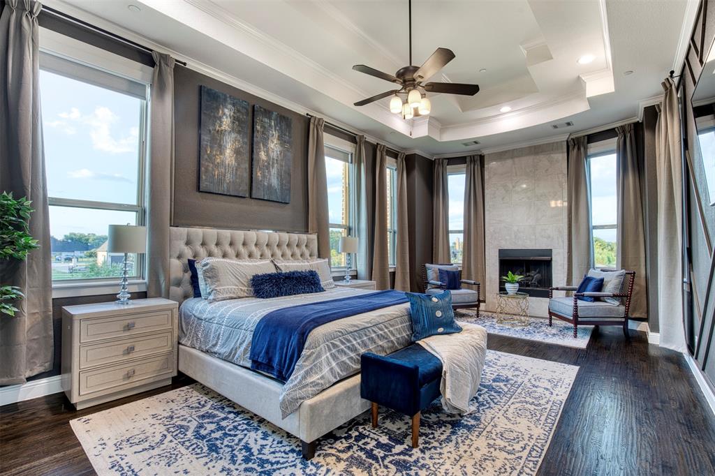 901 Inverness Court Lucas, TX 75002 - Photo 20 of 40 Bedroom with crown molding, dark wood-style floors, a tile fireplace, and ceiling fan