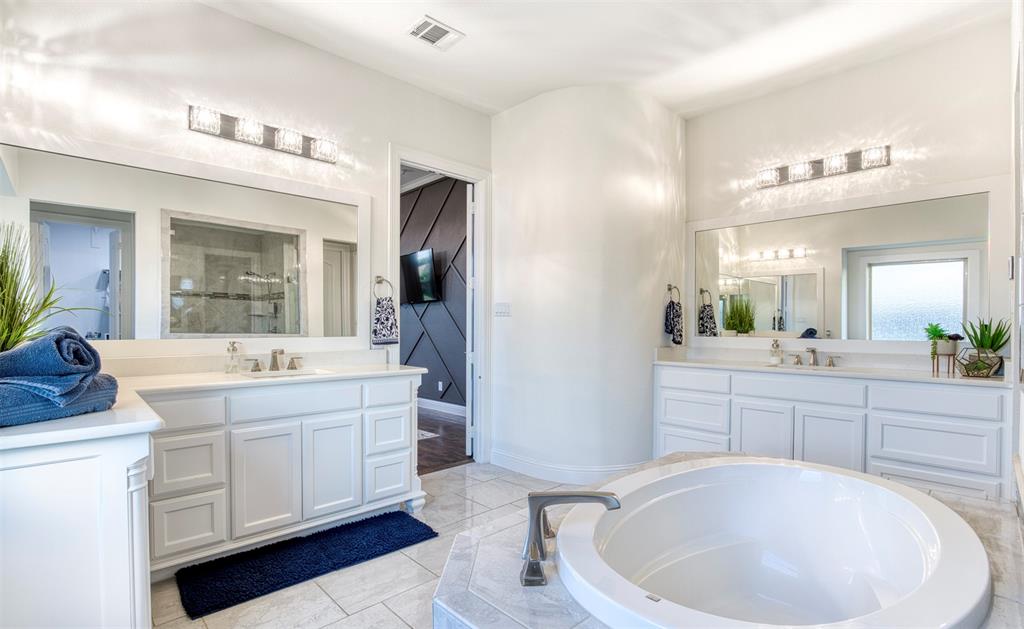 901 Inverness Court Lucas, TX 75002 - Photo 23 of 40 Bathroom with two vanities, a garden tub, a shower stall, and light tile patterned floors