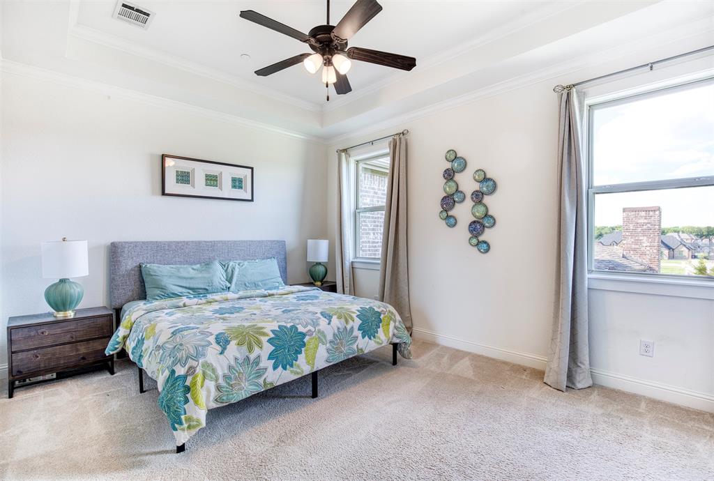901 Inverness Court Lucas, TX 75002 - Photo 25 of 40 Bedroom with light carpet, crown molding, a ceiling fan, and a tray ceiling