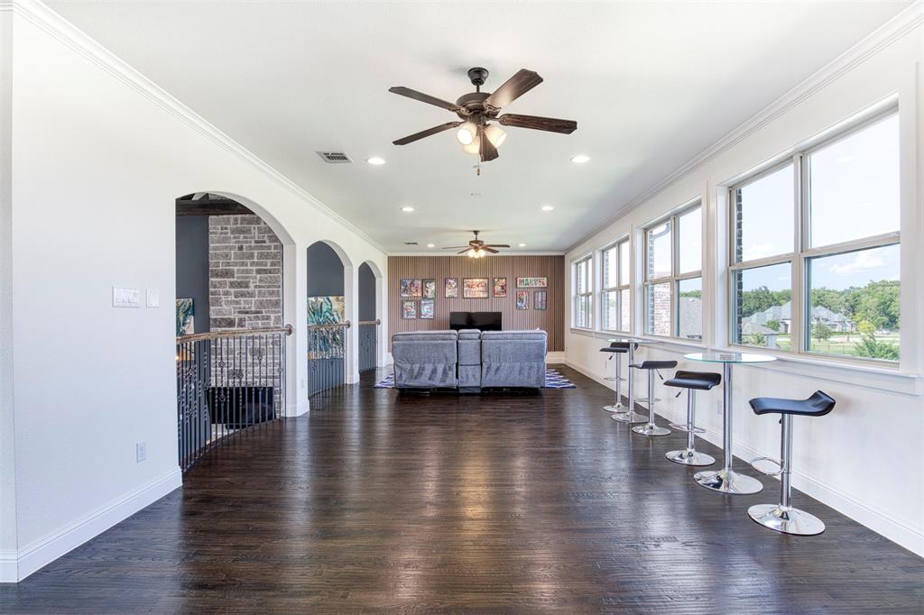901 Inverness Court Lucas, TX 75002 - Photo 27 of 40 Living room with dark wood finished floors, ornamental molding, recessed lighting, ceiling fan, and arched walkways