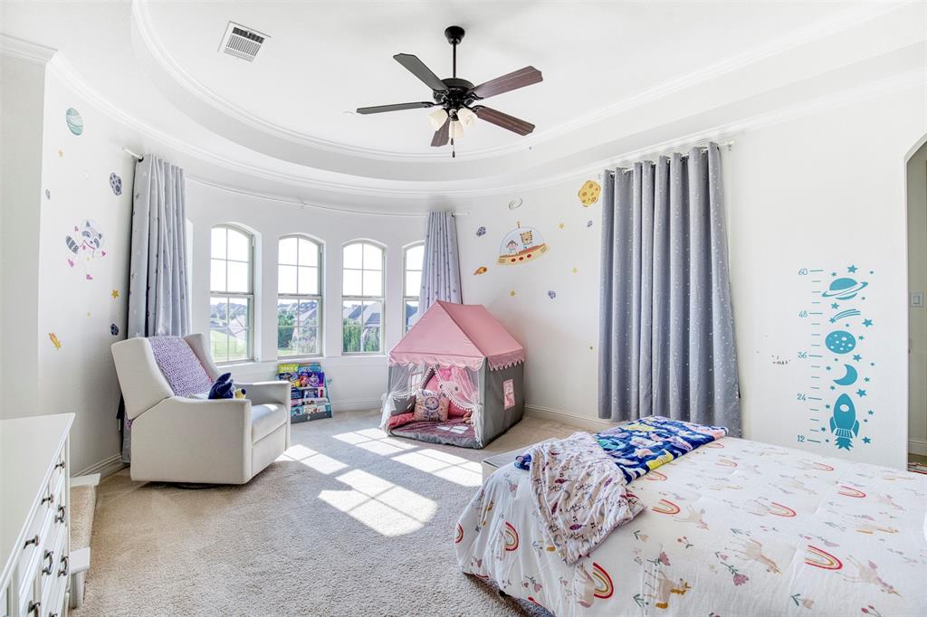 901 Inverness Court Lucas, TX 75002 - Photo 30 of 40 Bedroom with a ceiling fan, light carpet, a raised ceiling, ornamental molding, and arched walkways