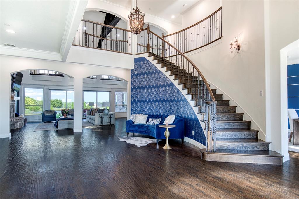 901 Inverness Court Lucas, TX 75002 - Photo 3 of 40 Stairs featuring arched walkways, hardwood / wood-style floors, a high ceiling, crown molding, and hanging lights