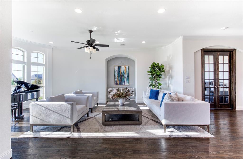 901 Inverness Court Lucas, TX 75002 - Photo 5 of 40 Living room with french doors, arched walkways, dark wood-style flooring, crown molding, and recessed lighting