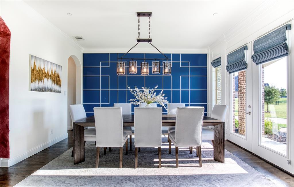 901 Inverness Court Lucas, TX 75002 - Photo 7 of 40 Dining room featuring an accent wall, wood finished floors, ornamental molding, and arched walkways